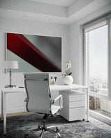 Modern office setup with a desk, chair, and abstract painting.