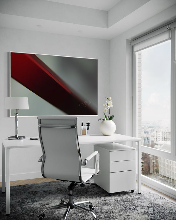 Modern office setup with a desk, chair, and abstract painting.